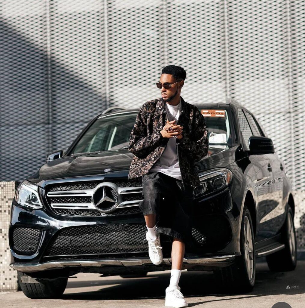 Crispdal Biography, Age, Girlfriend, Net Worth & Source of Wealth 2 a picture of crispdal posing in front of his black mercedez benz gle